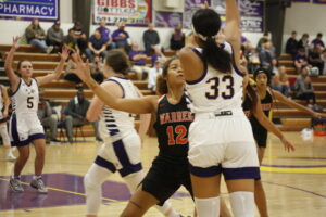 A group of women playing basketball on a court.
