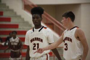Two men in white and black basketball uniforms.