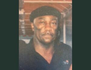 A man wearing a black hat and shirt.
