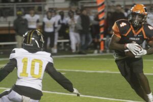 A football player running for the goal line.