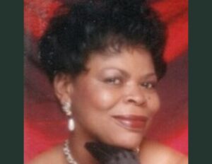 A woman with black hair and wearing a necklace.