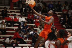 A basketball player jumping up to dunk the ball