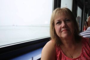 A woman sitting in front of a window.