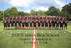 A group of football players posing for a picture.