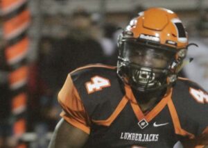 A football player wearing an orange helmet and uniform.