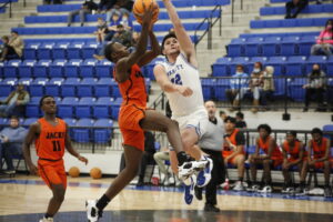 A basketball player is going to the basket.