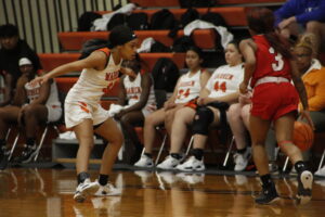 A group of girls playing basketball on the court.