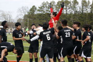 A group of men on a field playing soccer.