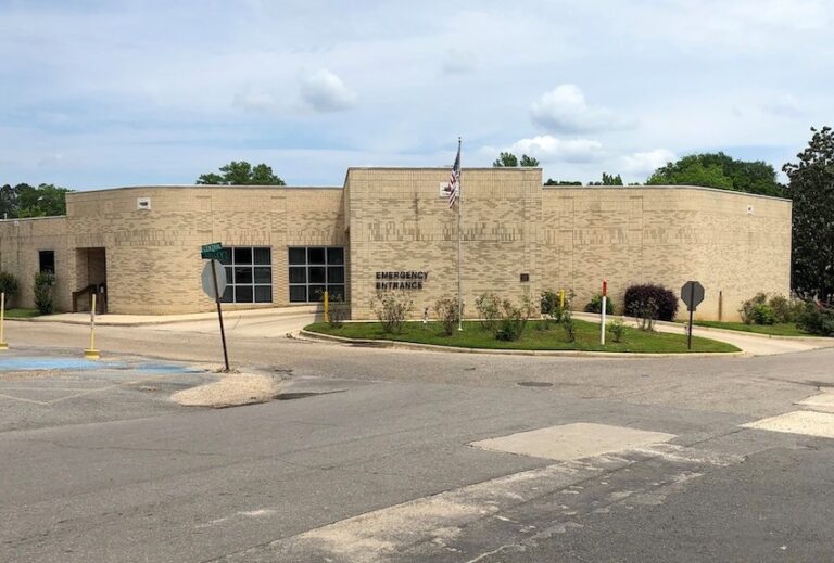 A building with a street sign on the corner.