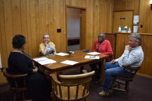 A group of people sitting around a table.