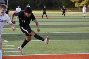 A soccer player is running on the field.