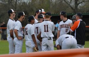 A group of baseball players standing on top of a field.