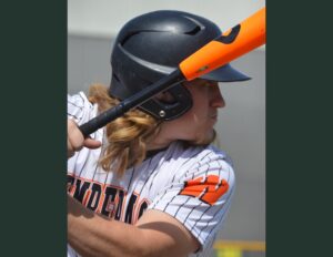 A baseball player holding a bat over his head.