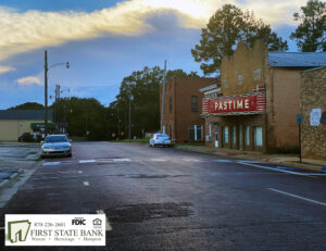 A street with cars parked on the side of it.