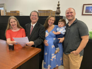 A group of people standing around each other.