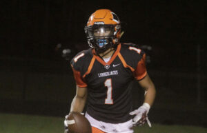 A football player in an orange and black uniform.