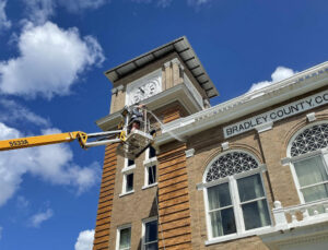 A crane is lifting up the clock tower.