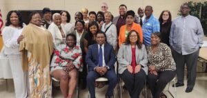A group of people sitting in chairs posing for the camera.