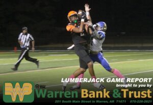 A football player is in the middle of an interception.