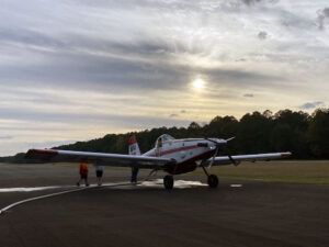 A small airplane sitting on top of an airport runway.
