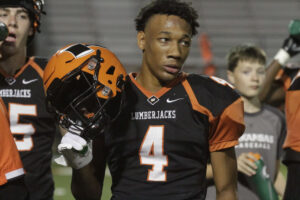 A football player holding onto his helmet