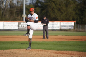 A baseball player is throwing the ball on the field.