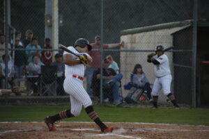 A baseball player swinging at the ball during a game.