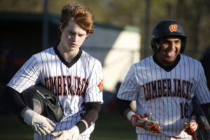 Two baseball players are standing on a field.