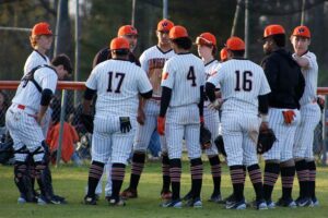 A group of baseball players standing on top of a field.