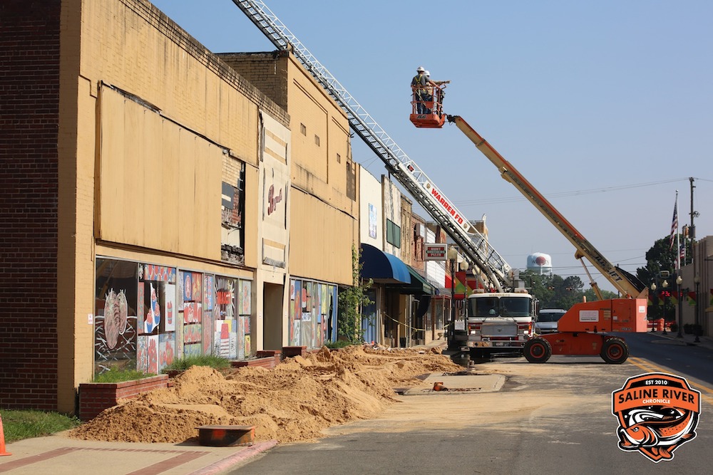 A crane is in the air over a construction site.