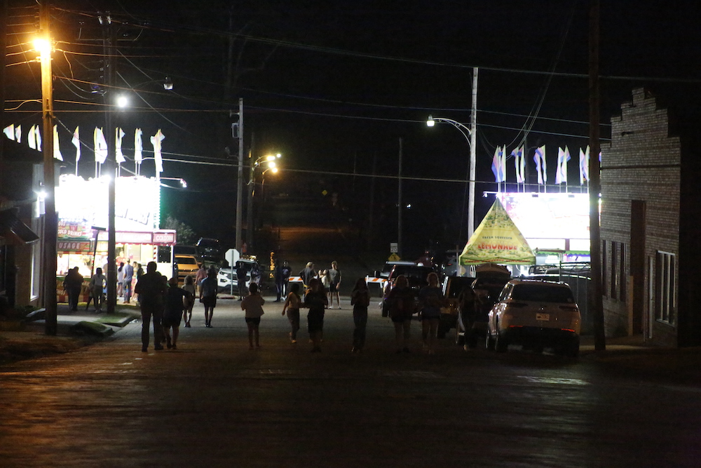 A man standing next to some ropes and a horse.