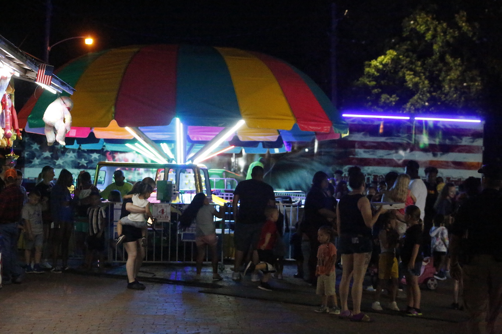 A man standing next to some ropes and a horse.