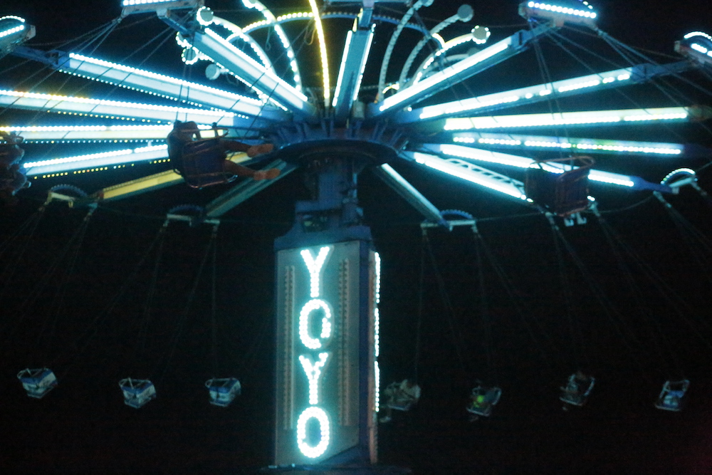 A man standing next to some ropes and a horse.