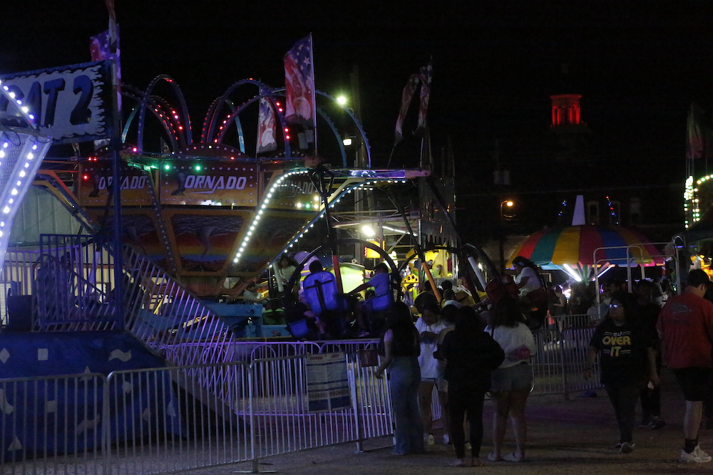 A man standing next to some ropes and a horse.