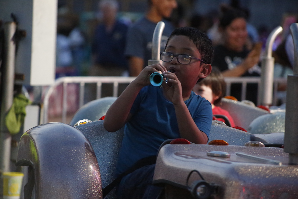 A man standing next to some ropes and a horse.