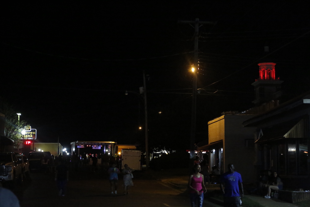 A man standing next to some ropes and a horse.