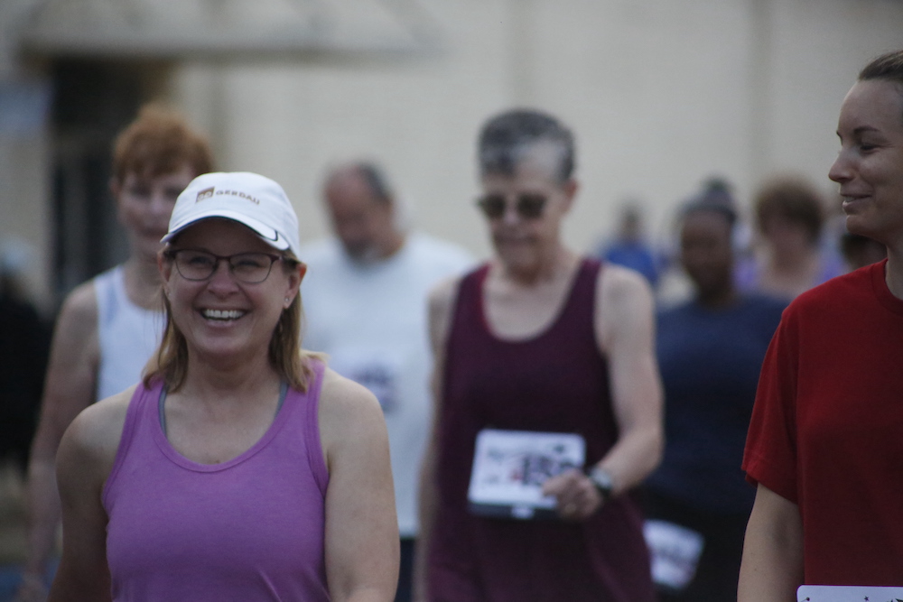 A man standing next to some ropes and a horse.