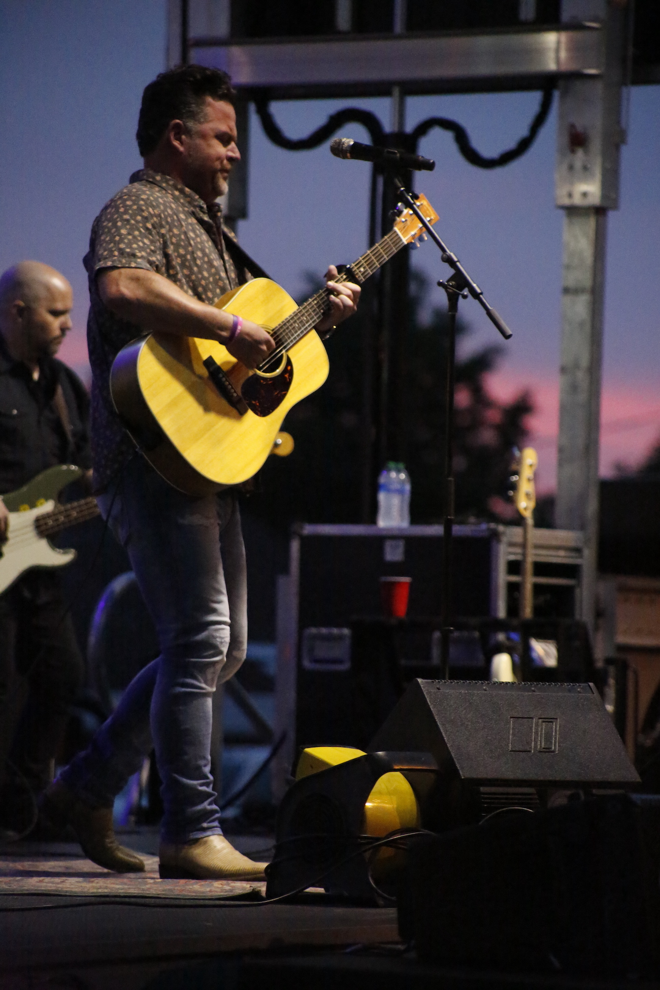 A man standing next to some ropes and a horse.