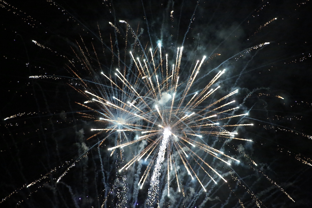 A man standing next to some ropes and a horse.