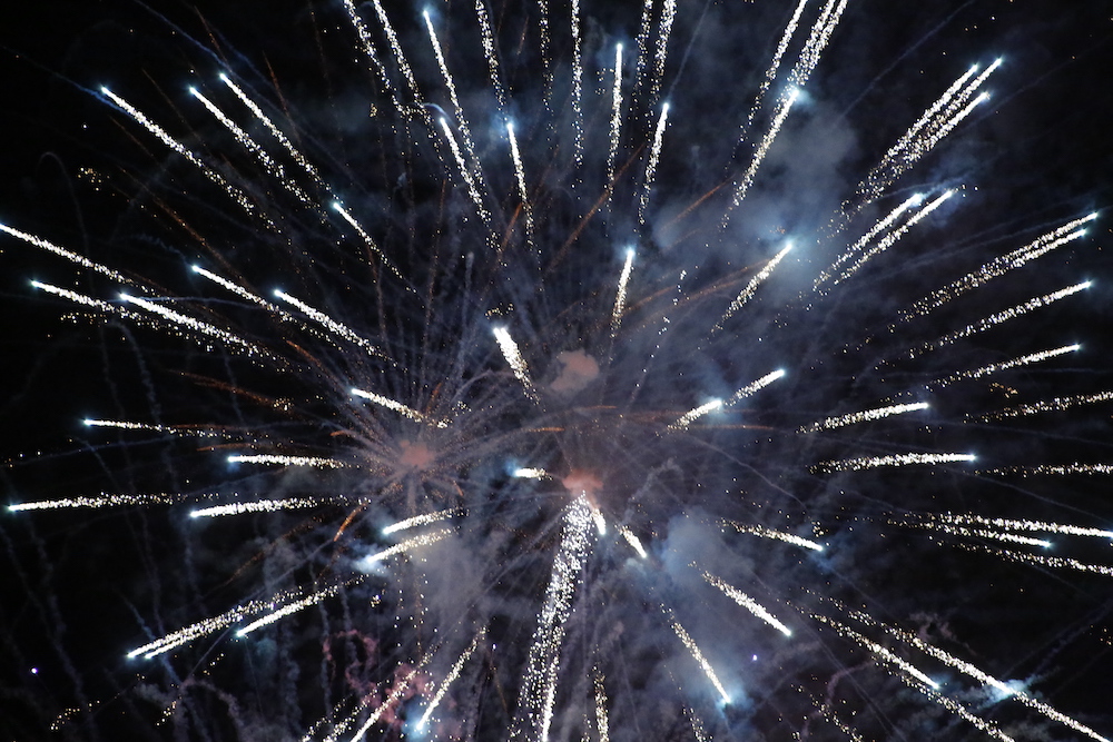A man standing next to some ropes and a horse.