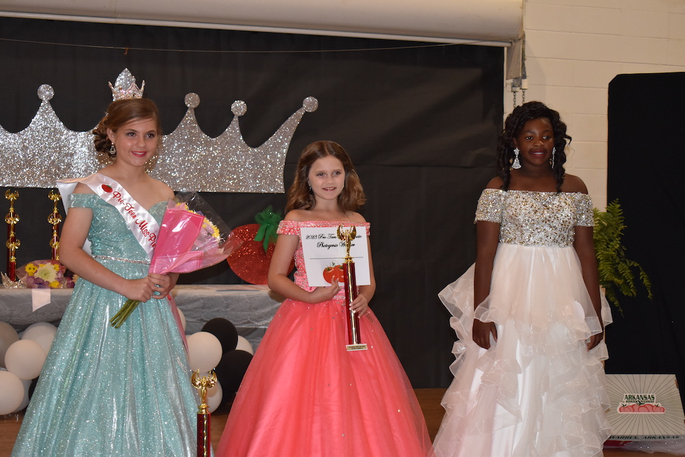 Three girls in dresses and a crown