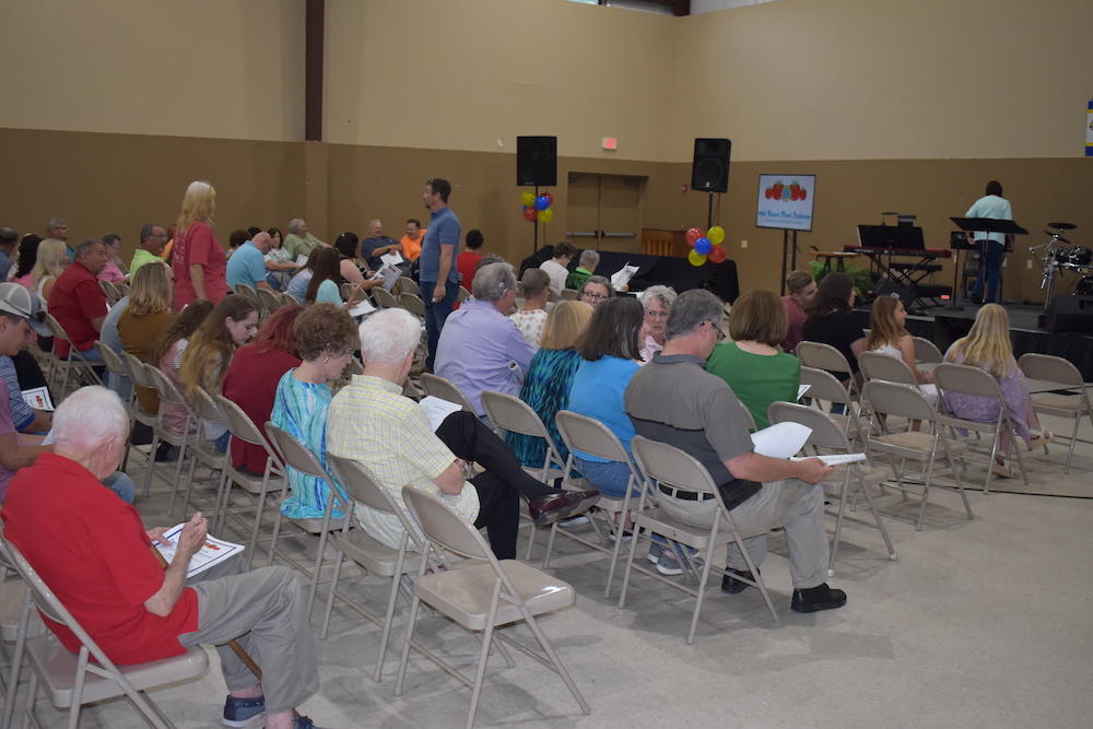 A large group of people sitting in chairs.