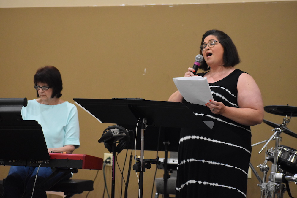 A woman is singing into a microphone