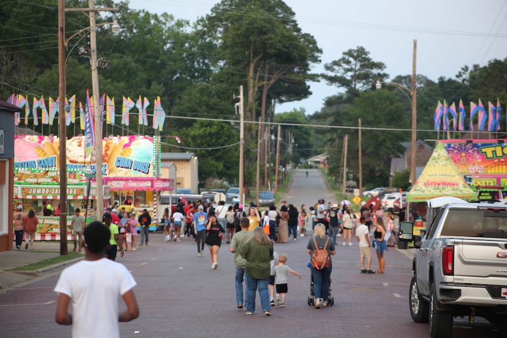 A crowd of people walking down the street.