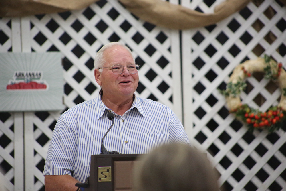A man standing at a podium in front of a crowd.