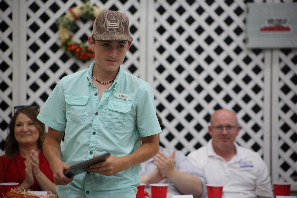 A man standing in front of two people.