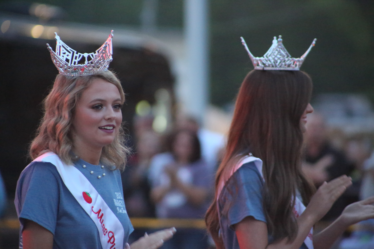 Two women in crowns are standing next to each other.