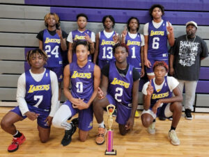 A group of young men holding a trophy.