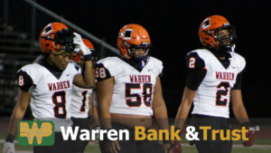 A group of football players standing on top of a field.