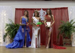 Three women in formal wear posing for a picture.